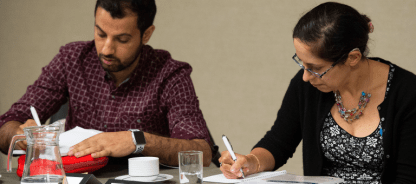 Two doctors busy with reflective writing