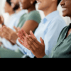 Audience applauding a doctor's presentation